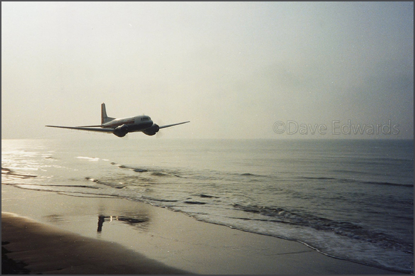 C-117D skimming the shoreline, by Dave Edwards (1990)